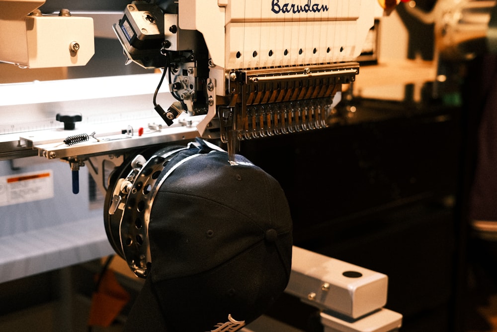 Multi-head commercial embroidery machine stitching a cap at Delaware County Shirt Printing, Upper Darby PA